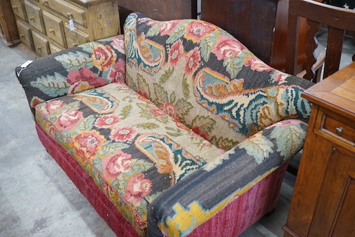 An early 20th century carpet upholstered scroll arm two seater settee, length 150cm, depth 80cm, height 80cm